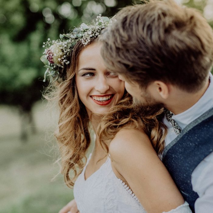 Beautiful bride and groom in green nature.